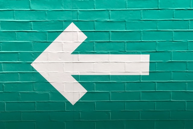 Left arrow on green background